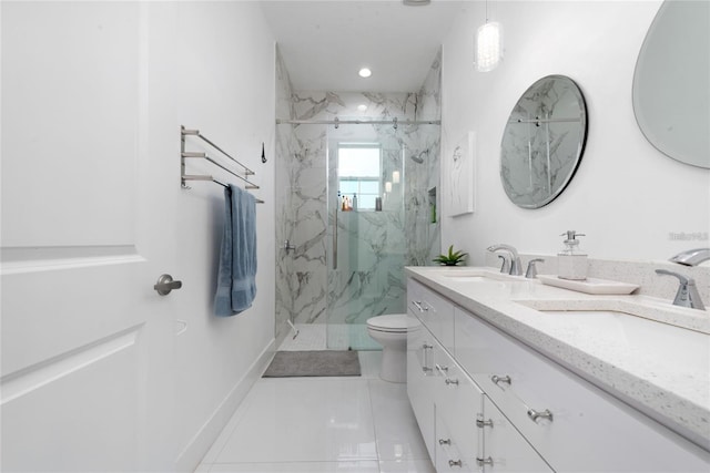 bathroom featuring toilet, baseboards, a sink, and a marble finish shower