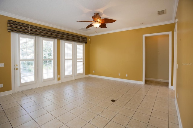 empty room with visible vents, ornamental molding, a ceiling fan, light tile patterned flooring, and baseboards