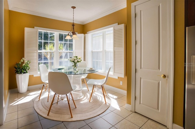 dining room featuring light tile patterned floors, baseboards, and ornamental molding