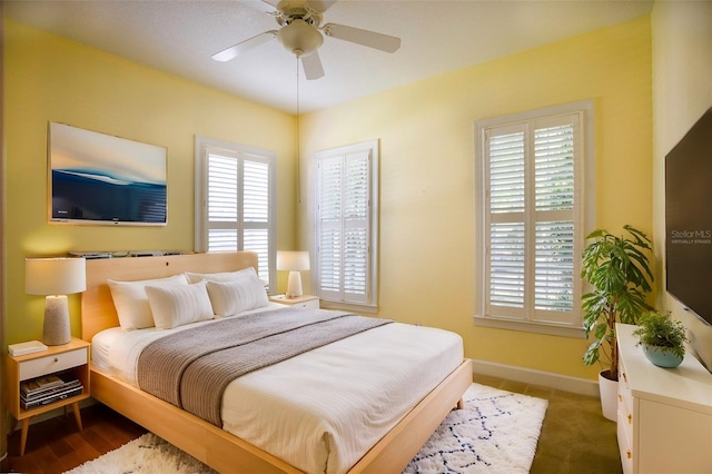 bedroom featuring baseboards and ceiling fan