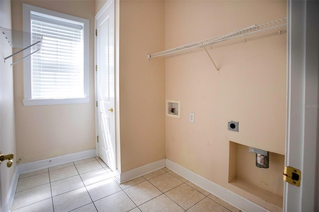 laundry room with light tile patterned floors, baseboards, hookup for an electric dryer, hookup for a washing machine, and laundry area