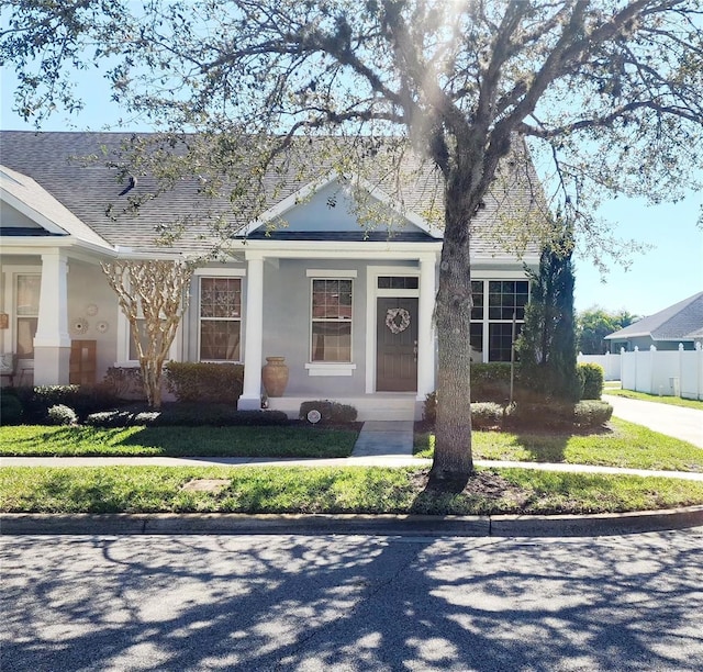 view of front of house with a shingled roof and stucco siding