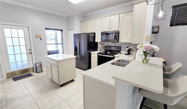 kitchen featuring a center island, backsplash, a sink, a peninsula, and black appliances