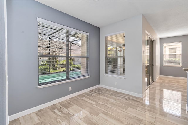 unfurnished room featuring baseboards