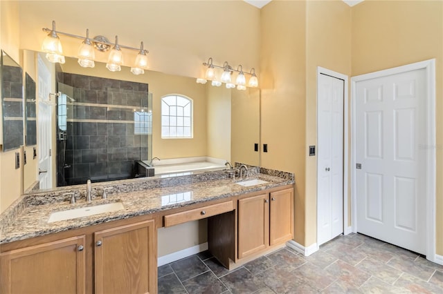 bathroom featuring a bath, a stall shower, baseboards, and a sink