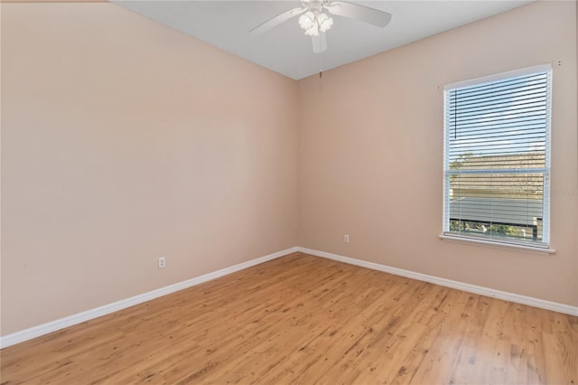 unfurnished room with light wood finished floors, ceiling fan, and baseboards