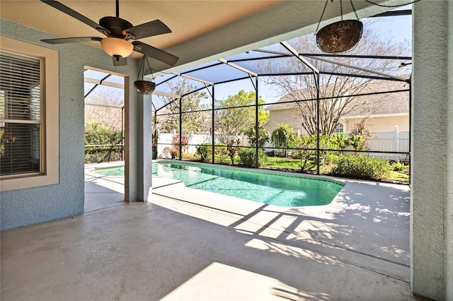 view of pool featuring ceiling fan, a lanai, fence, a fenced in pool, and a patio area