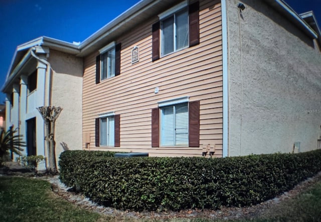 view of side of property featuring stucco siding