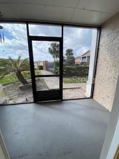 interior space with concrete flooring and a wall of windows