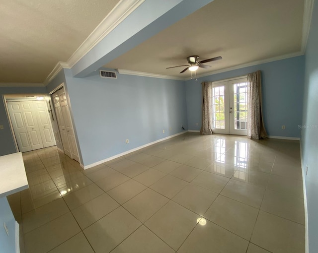 unfurnished room with visible vents, baseboards, tile patterned floors, crown molding, and french doors