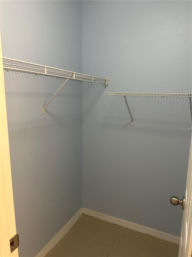 walk in closet featuring tile patterned flooring