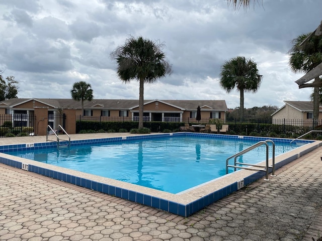 pool with a residential view and fence