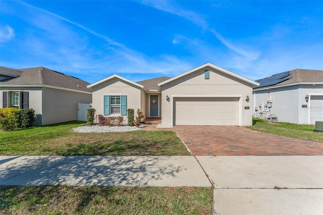 ranch-style house featuring a garage, a front lawn, decorative driveway, and stucco siding