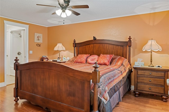 bedroom with crown molding, light wood-style flooring, a ceiling fan, a textured ceiling, and baseboards