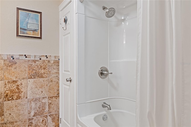 bathroom with shower / bath combo with shower curtain