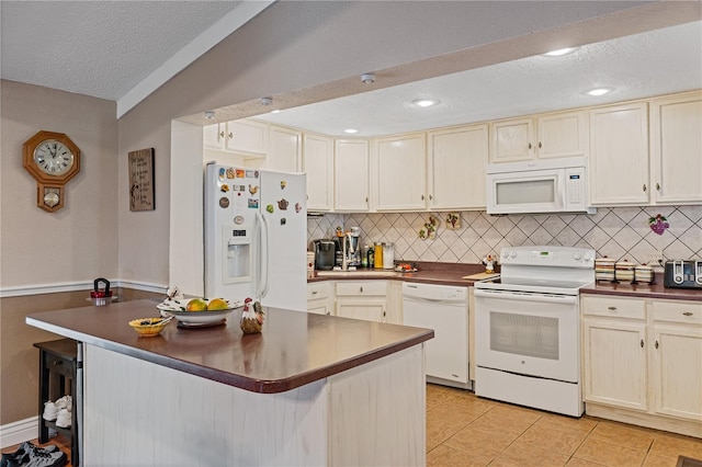 kitchen with dark countertops, white appliances, decorative backsplash, and light tile patterned floors