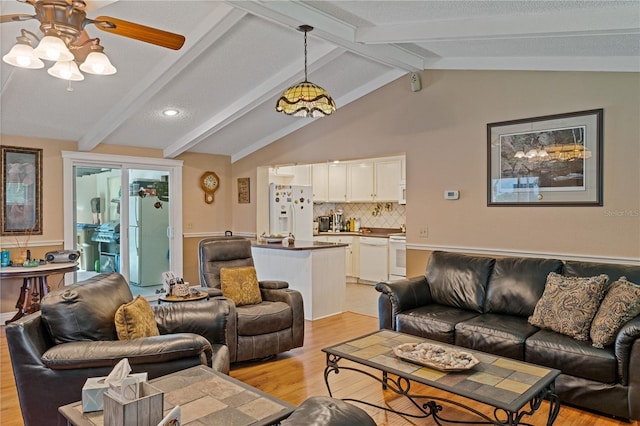 living area featuring lofted ceiling with beams, light wood-type flooring, and ceiling fan