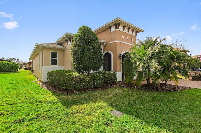 view of front of home with a front lawn and stucco siding