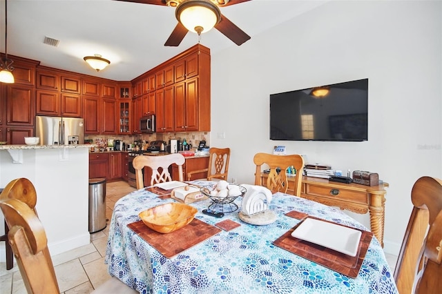 dining area featuring a ceiling fan, visible vents, and light tile patterned flooring