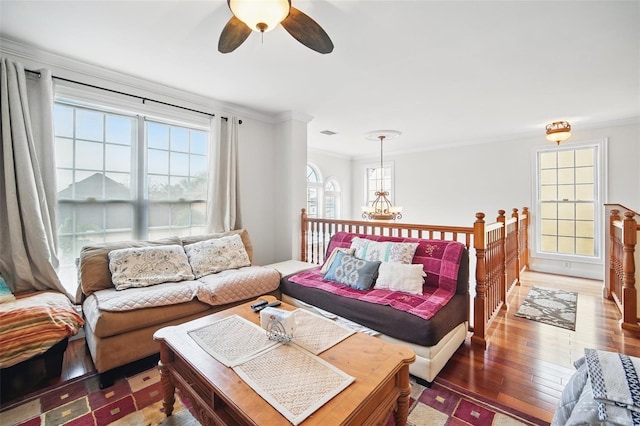 living area with ornamental molding, a chandelier, visible vents, and dark wood-style floors