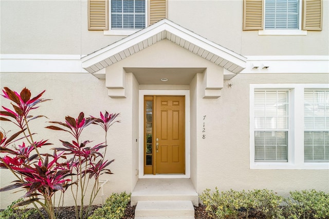 property entrance with stucco siding