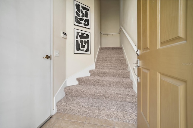 stairs featuring tile patterned floors