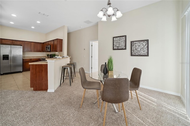 dining room featuring baseboards, visible vents, light colored carpet, a chandelier, and recessed lighting