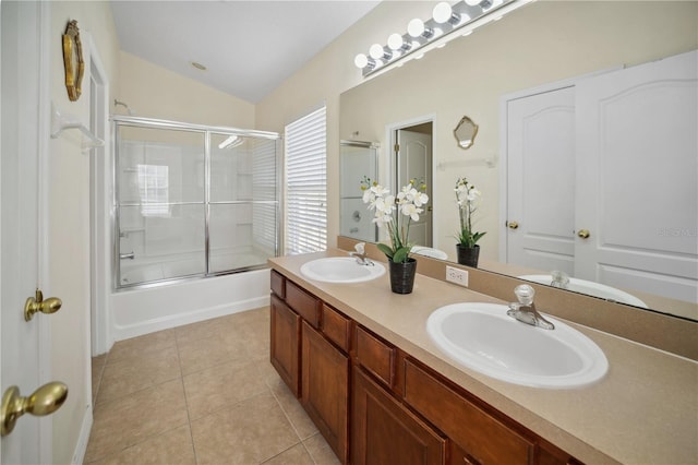 full bath with vaulted ceiling, a sink, and tile patterned floors