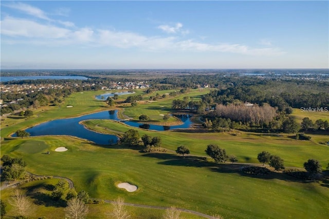 birds eye view of property with a water view and golf course view