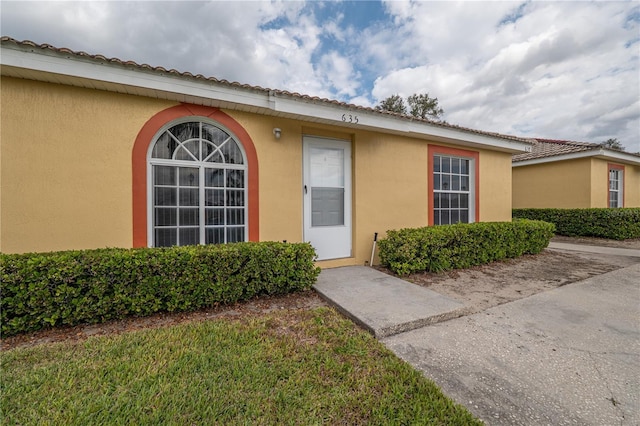 doorway to property with stucco siding