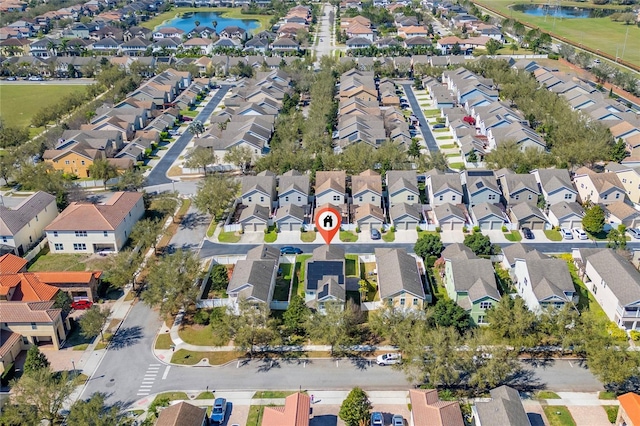 bird's eye view featuring a water view and a residential view