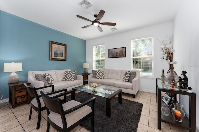 living area featuring visible vents, ceiling fan, baseboards, and light tile patterned floors