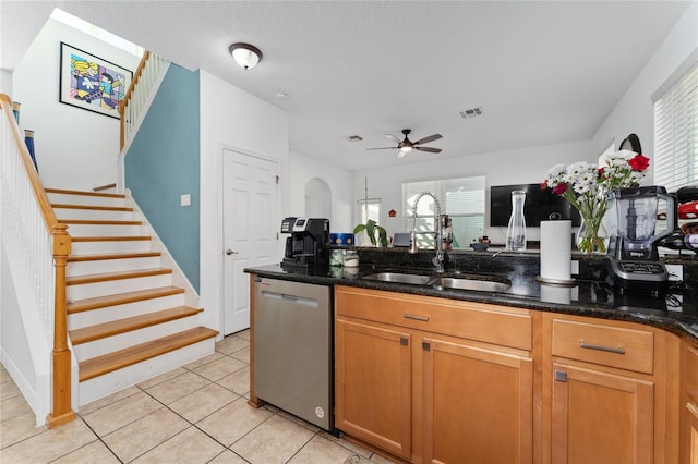 kitchen with plenty of natural light, visible vents, dark stone counters, dishwasher, and a sink