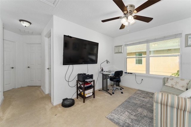 office with baseboards, a ceiling fan, visible vents, and light colored carpet