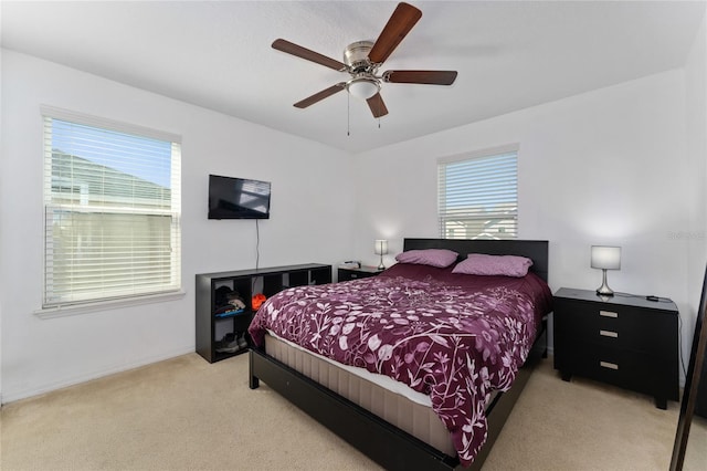 bedroom with light colored carpet and ceiling fan