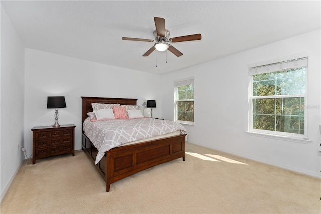 bedroom featuring light carpet and ceiling fan