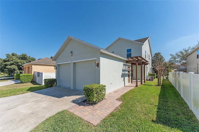 view of home's exterior featuring driveway, a garage, fence, a yard, and stucco siding