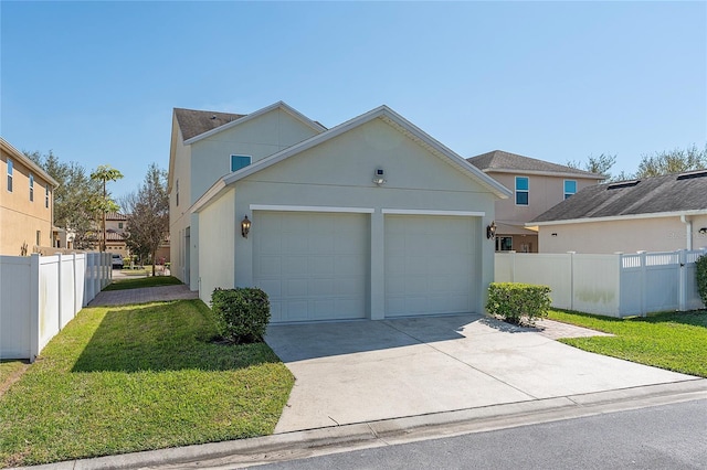 view of front of property with a garage, fence, concrete driveway, stucco siding, and a front yard