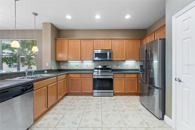 kitchen featuring dark countertops, brown cabinetry, and stainless steel appliances