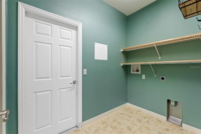 laundry area with baseboards, washer hookup, laundry area, tile patterned floors, and electric dryer hookup