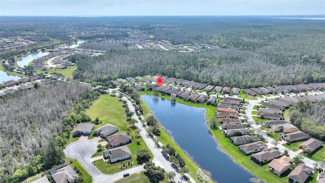 birds eye view of property featuring a residential view, a wooded view, and a water view