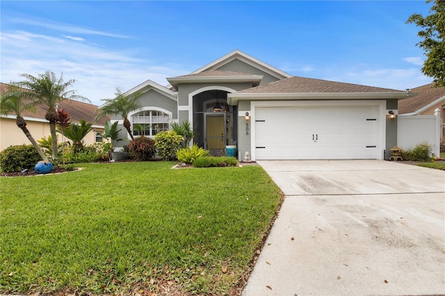 single story home with an attached garage, a front yard, concrete driveway, and stucco siding