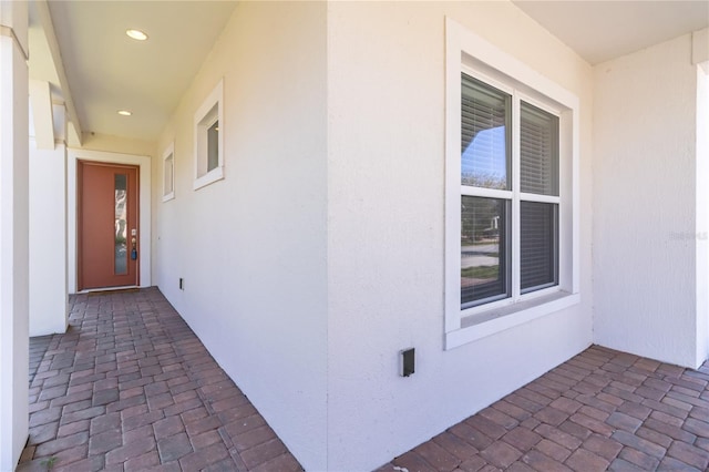 property entrance with stucco siding