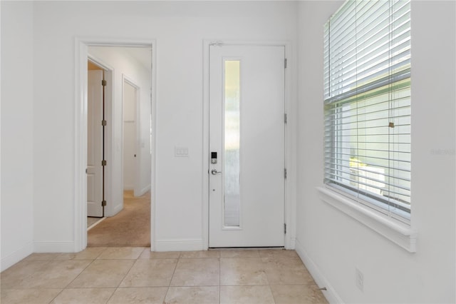 entrance foyer featuring baseboards and light tile patterned flooring