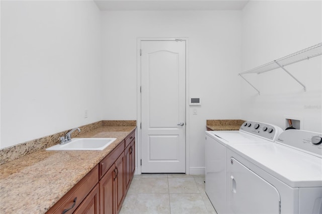 laundry room featuring washer and dryer, a sink, and light tile patterned flooring