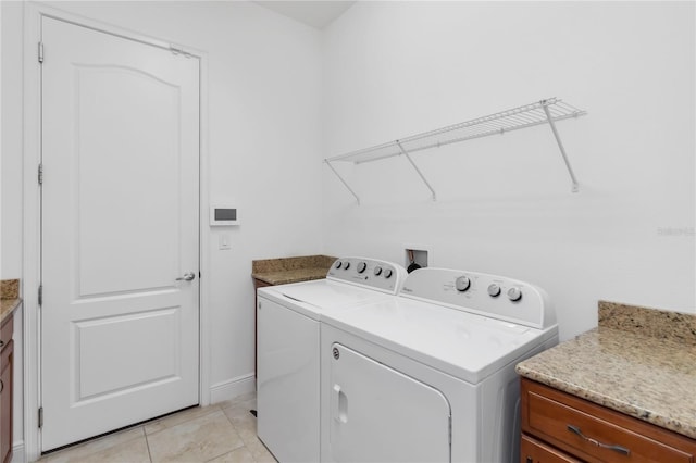 laundry room with washer and dryer, laundry area, and light tile patterned floors