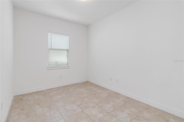 unfurnished room featuring baseboards