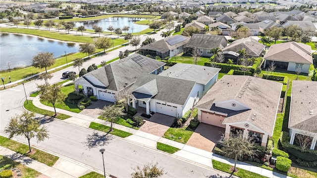 drone / aerial view with a residential view and a water view