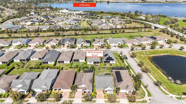 drone / aerial view with a water view and a residential view