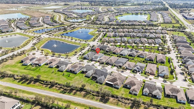 drone / aerial view with a residential view and a water view